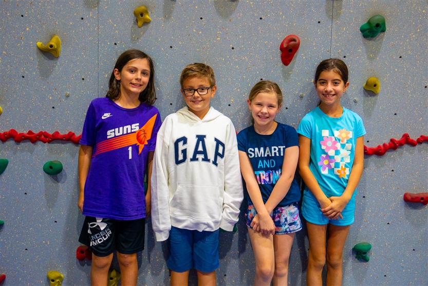 Students smile during an assembly